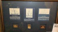 Overall view of framed tall ships gold ingot display showing three panels and ingots