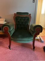 Full view of green tufted Victorian armchair