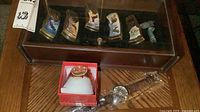 Overall lot showing display case with knives, Geneva watch in box and Kings watch in sleeve