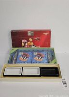 Boxed Cypress acrylic tray with napkins and knives plus ceramic olive dish set packaging visible