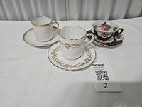 Three demitasse cup and saucer sets side by side