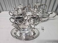 Entire nine-piece silver-plated service displayed on table
