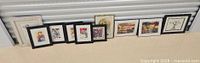 All ten framed artworks lined up