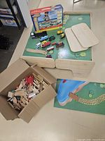 Overview of table with accessories and boxed set, plus open box of additional pieces