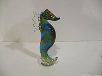 Front view of multicolour glass seahorse on clear base