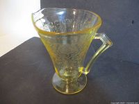 Yellow Florentine glass pitcher angled view