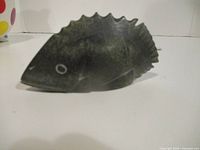 Left side view of carved soapstone fish showing overall shape and colour