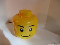 Full view of LEGO storage head showing face and lid