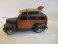 Left front side of metal Woody model showing surfboards