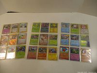Full layout of 24 holo Pokémon cards in binder sleeves