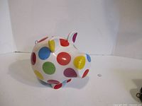 Right side view of ceramic polka dot piggy bank