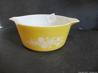 Side view of yellow Pyrex bowl showing floral pattern