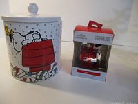 Cookie jar and boxed ornament side by side
