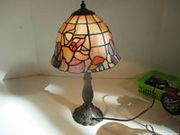 Full view of lamp illuminated showing shade, base, power cord