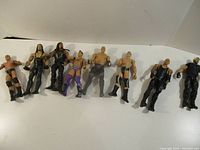 All eight wrestling figures lined up side by side on white background