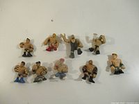 Top view of all nine mini wrestling figures on white background