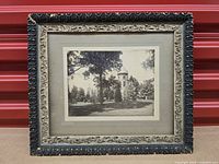Front view of framed photograph showing ornate border and image