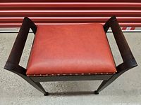 Top view showing red leather seat and walnut frame