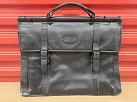 Front view of black Bugatti leather business handbag with top handle and flap