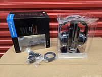 Full set showing headphones in clamshell, outer box, sealed cables