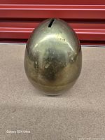 Front view showing egg shape and coin slot