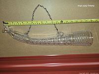 Full view with tape measure showing length of horn vase and hanging chain