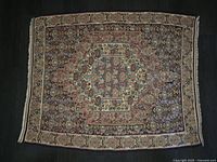 Full view of the rug showing entire design, colours and fringes