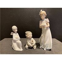 Front view of three porcelain figurines