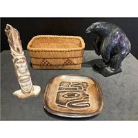 Group shot showing all four items—basket, soapstone bear, carved figure, ceramic plate