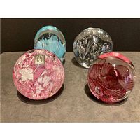 Group view of four spherical paperweights