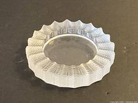 Top view of Lalique crystal ashtray showing leaf motif and scalloped edge