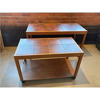 Both teak tables side by side showing size difference and wheels