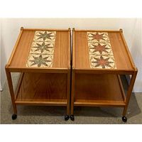Both teak trollies side by side showing overall design, tile tops, shelves, casters