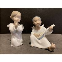 Front view of both angel figurines showing poses and details