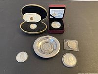 Group shot of six silver items including presentation-boxed coins, Peruvian dish and loose coins