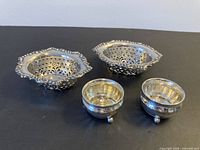 Top view showing two reticulated nut dishes and two footed salt cellars