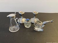 Group view of all five silver and glass pieces