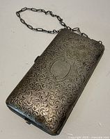 Closed engraved coin purse compact with chain