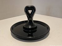 Full view of black glass tray showing shape and handle