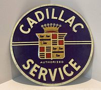 Front view of Cadillac Service metal sign showing crest and lettering
