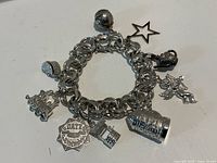 Front view of sterling charm bracelet with nine charms visible