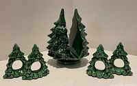 Front view of green ceramic Christmas tree napkin holder and four matching tree napkin rings