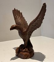 Front view of brown eagle statue with wings raised