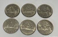 Six Voyageur dollar reverse sides showing canoe design and dates