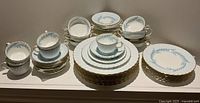 Full set of Minton Symphony china showing plates, bowls, cups and saucers