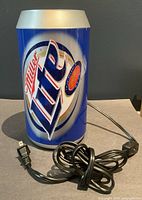 Front view of Miller Lite beer can lamp with power cord visible