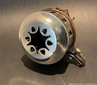 Front view showing star-shaped aperture and maker's mark