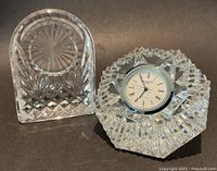 Clock in octagonal base beside empty arched base