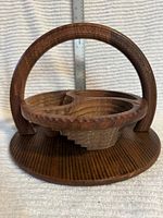 Overall view of wooden bowl with handle raised on base