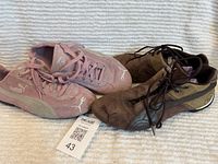 Both pairs of Puma sneakers side by side